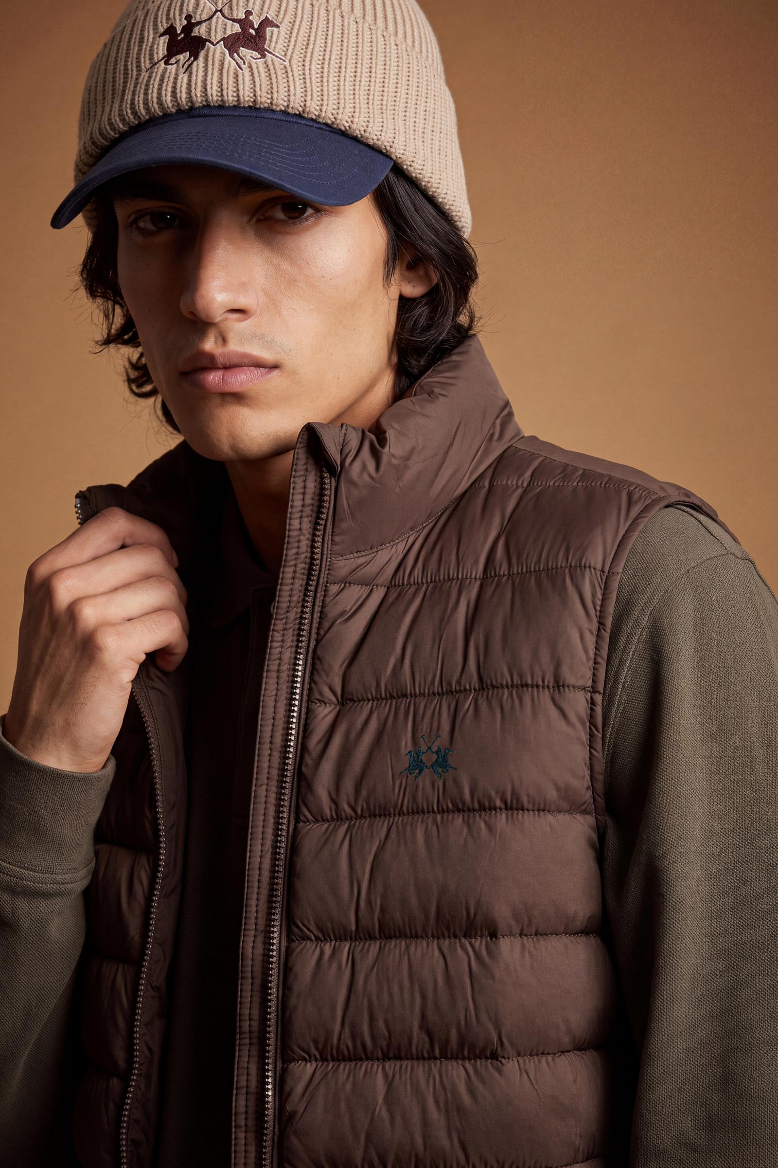 Men's sleeveless down jacket in lightweight nylon with wadding padding for warmth, zippered pockets, high collar, and contrasting interior and logo details. - Hot Fudge