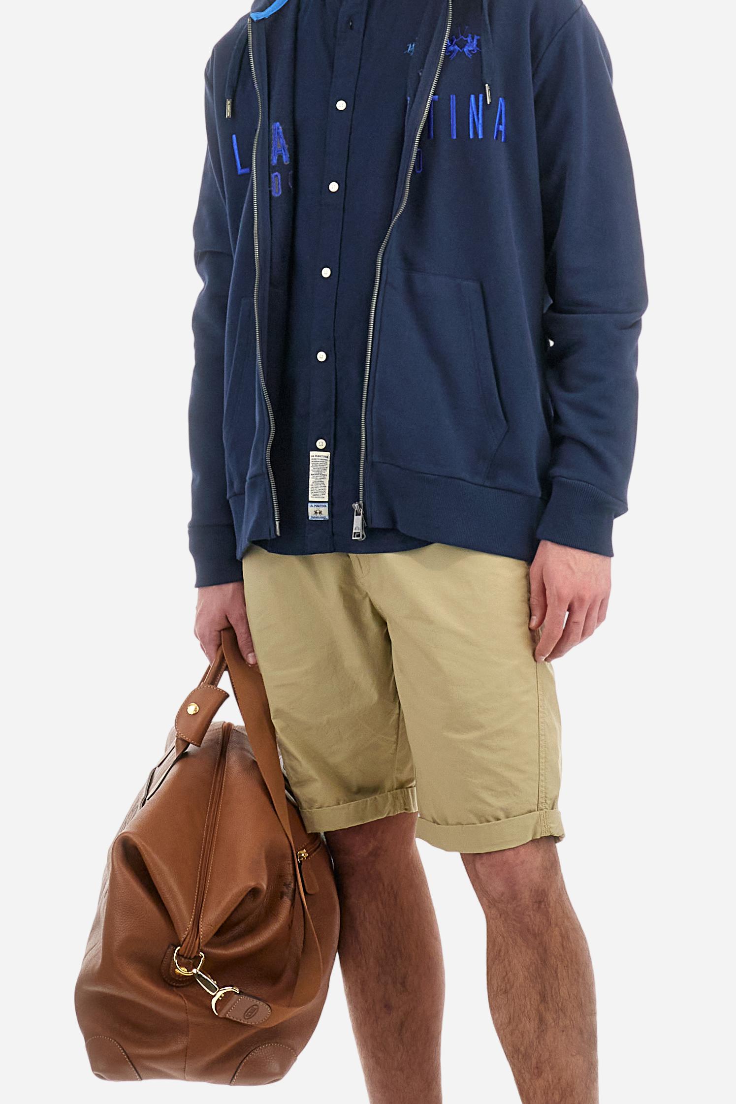 Men's plain long-sleeved shirt made from linen canvas. It features a button-down collar and a basic, traditional design, with woven labels at the bottom of the opening. The logo is embroidered on the chest, over the heart, in tone-on-tone thread. Regular fit. The model is wearing a size L. - Navy