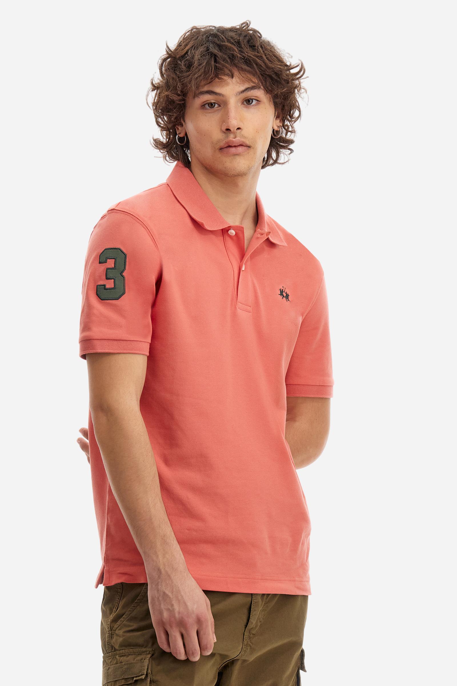 Men's plain short-sleeved polo shirt made from stretch piqué. Two-button fastening. The collar and cuffs are made from tone-on-tone ribbed fabric. A contrasting fabric patch depicting the number 3 is appliquéd on the right sleeve. The logo is embroidered on the left side of the chest in contrasting thread. Under the collar, there is a large contrasting print of the La Martina lettering. Regular fit. The model is wearing a size L. - Acai