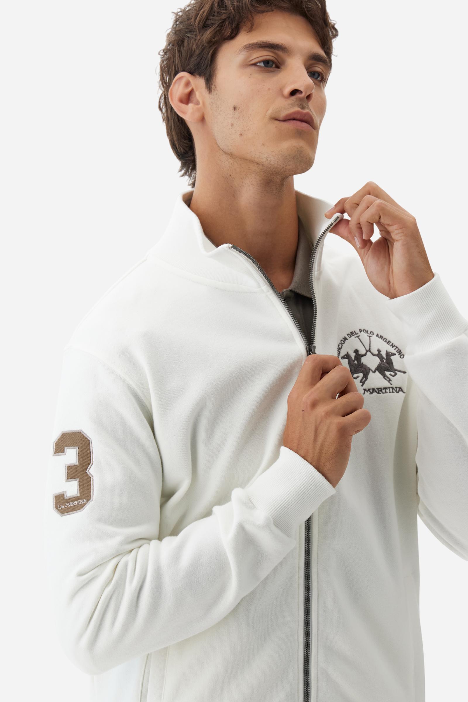 Men's long-sleeved solid colour sweatshirt. It is made of comfortable 100% cotton fleece with a soft-brushed feel. Model with high ribbed neck and front zip opening. Solid colour ribbed cuffs and waistband. The large contrasting brand team logo is embroidered on the chest. A contrasting colour fabric number patch is applied to the right sleeve. The model has a regular fit that offers a comfortable, relaxed silhouette. The model is wearing a size L. - Off White