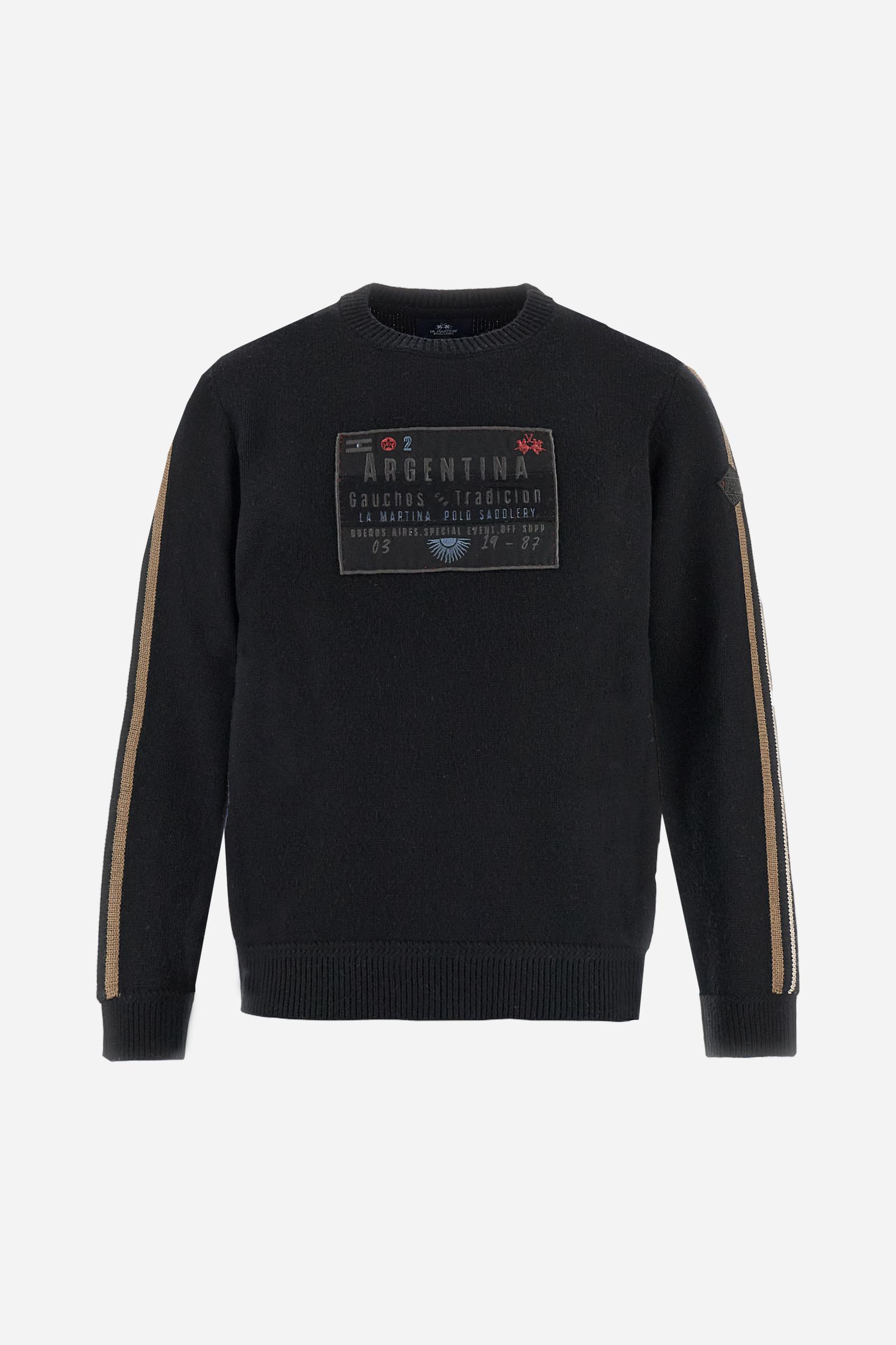 Full-zip men’s sweater in lambswool blend, soft and resistant. Ribbed collar, cuffs, and hem in matching tone. Multicolor striped knitted bands run along the sleeves. A large embroidered patch dedicated to Argentina dominates the chest, complemented by additional embroidered patches on the left sleeve. Relaxed, comfortable fit for distinctive everyday style. Model wears size L. - Black