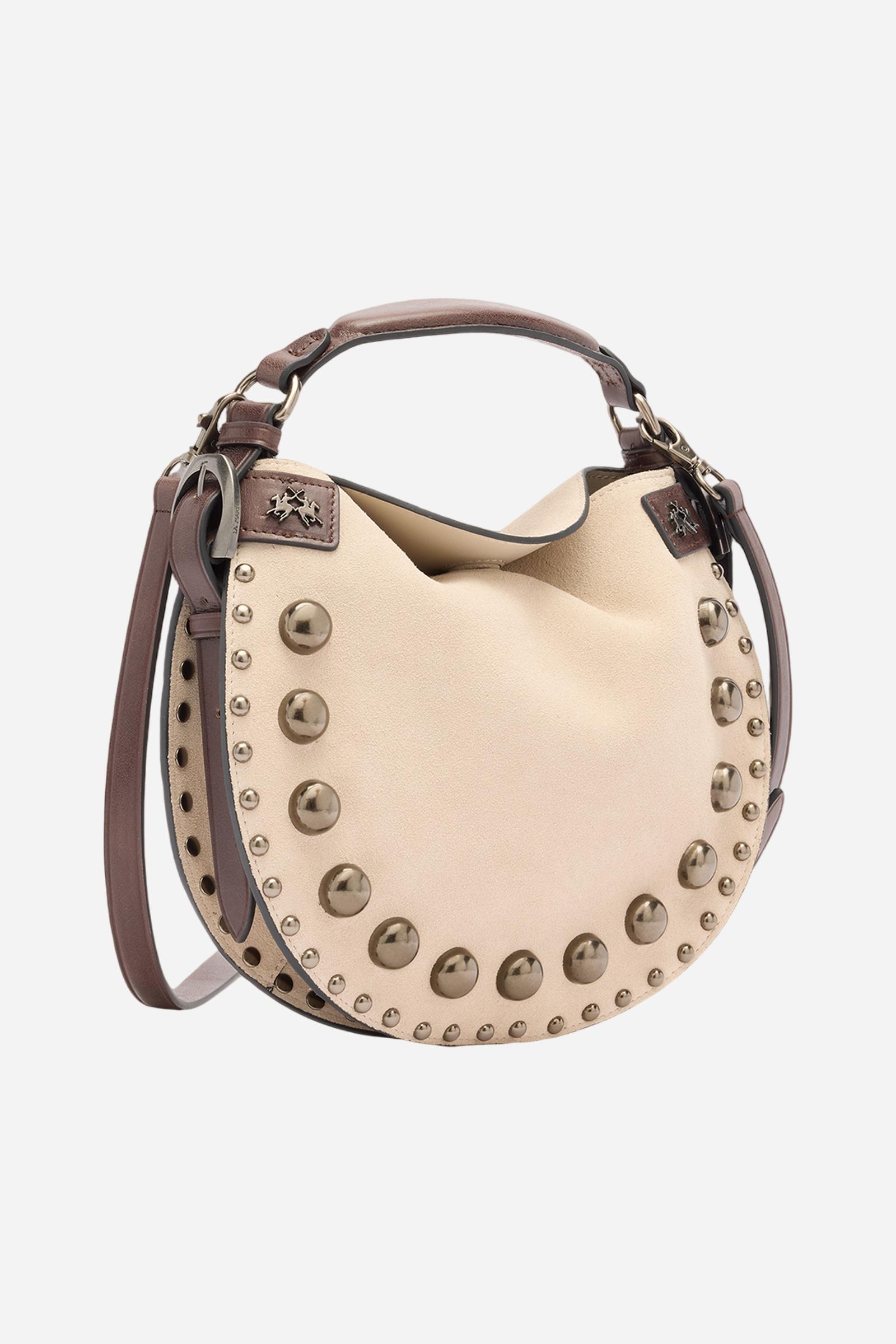 Medium-sized half-moon bag made of suede in a solid colour with side leather inserts and the brand’s signature metallic logo. Hidden magnetic closure, structured handle and contrasting leather shoulder strap. Front decorated with metallic studs of different sizes creating a refined play of light and volume. - SILK/DARK CHOCOLATE