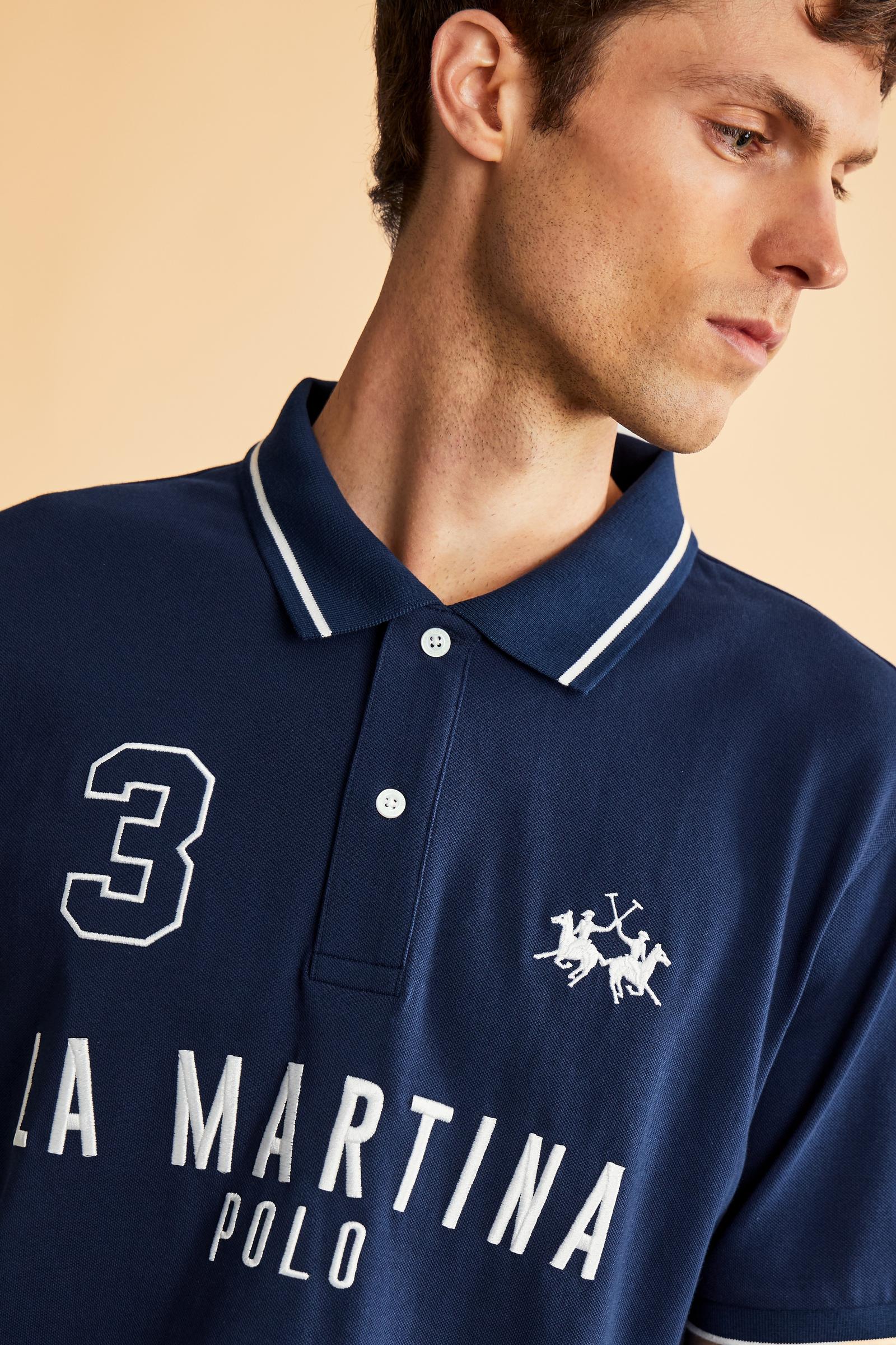 Men's short-sleeve polo in stretch piqué fabric with ribbed details, embroidered logo, bold lettering, and a relaxed regular fit for versatile comfort. - Navy