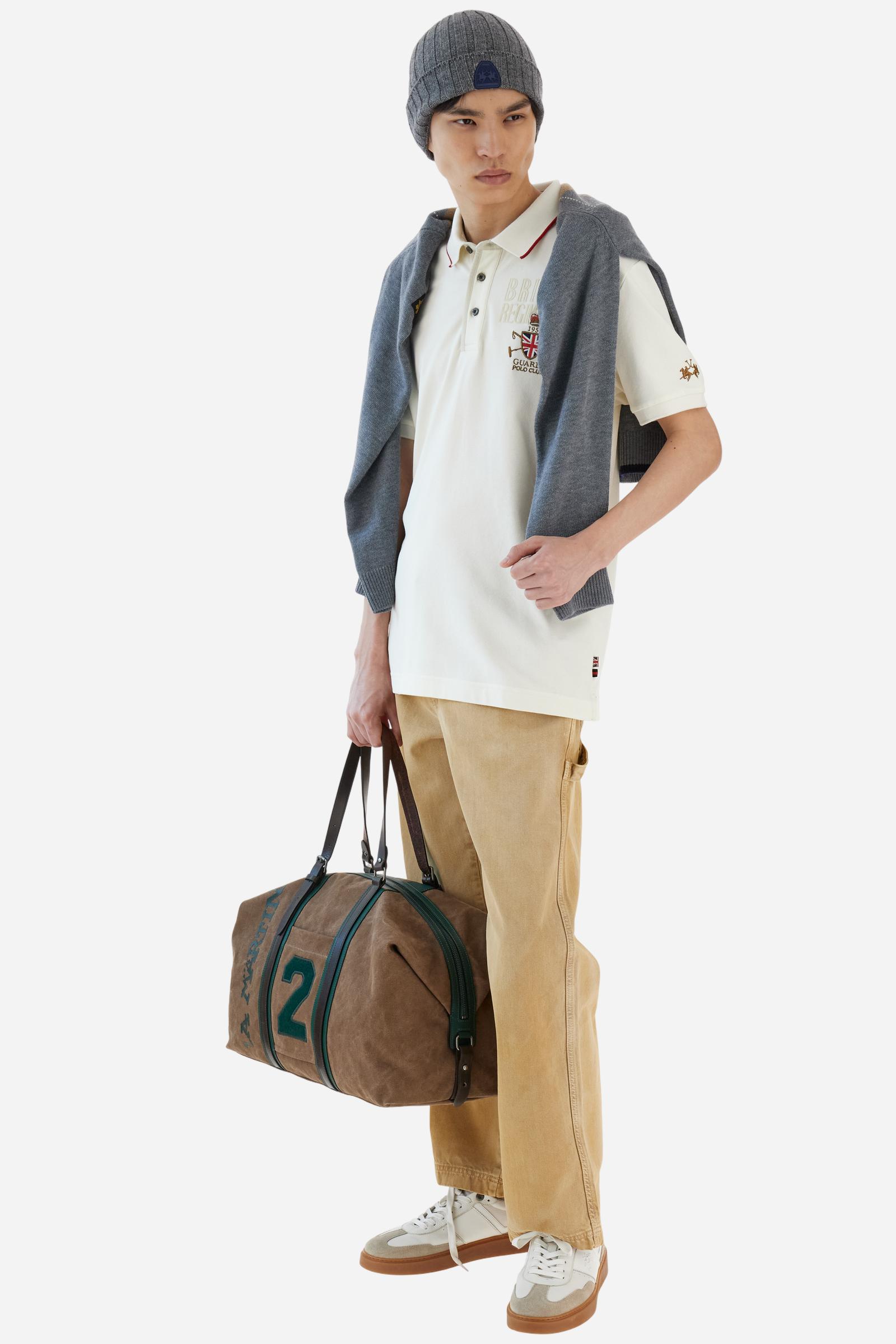 Short-sleeve polo shirt from the Guards capsule, made of high-quality stretch cotton piqué. Ribbed collar and cuffs in matching tone, with contrast striped detail on the collar. Three-button personalized placket. Multicolor graphics, patches, and lettering celebrate the British regiment, applied to chest and sleeves. Brand logo embroidered in contrast on the left sleeve. Regular straight fit. Model wears size L. - Pristine