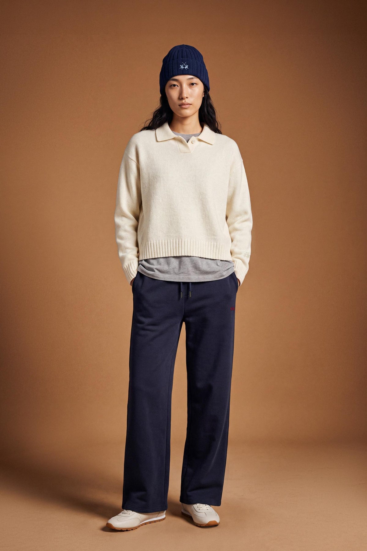 Women's long-sleeve knitted polo in soft lambswool blend, featuring a relaxed cropped fit, ribbed cuffs, shirt-style collar, and smooth, compact knit surface. - Antique White