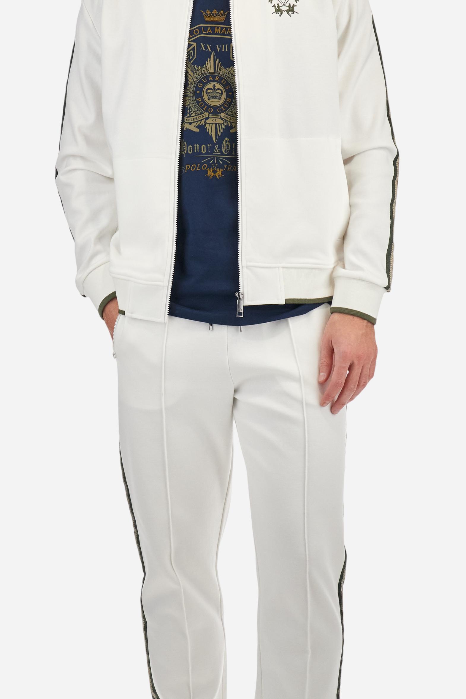 Single-colour men's jogging trousers made of lightweight cotton-blend interlock fleece. Drawstring waistband. Side pockets with matching zip fastening. On both sides, there are multicoloured striped jersey bands. The front features vertical ribbed detailing. The logo is embroidered in colour-contrasting thread on the back, under the strap, towards the right side. Regular fit. The model is wearing a size L. - Off White