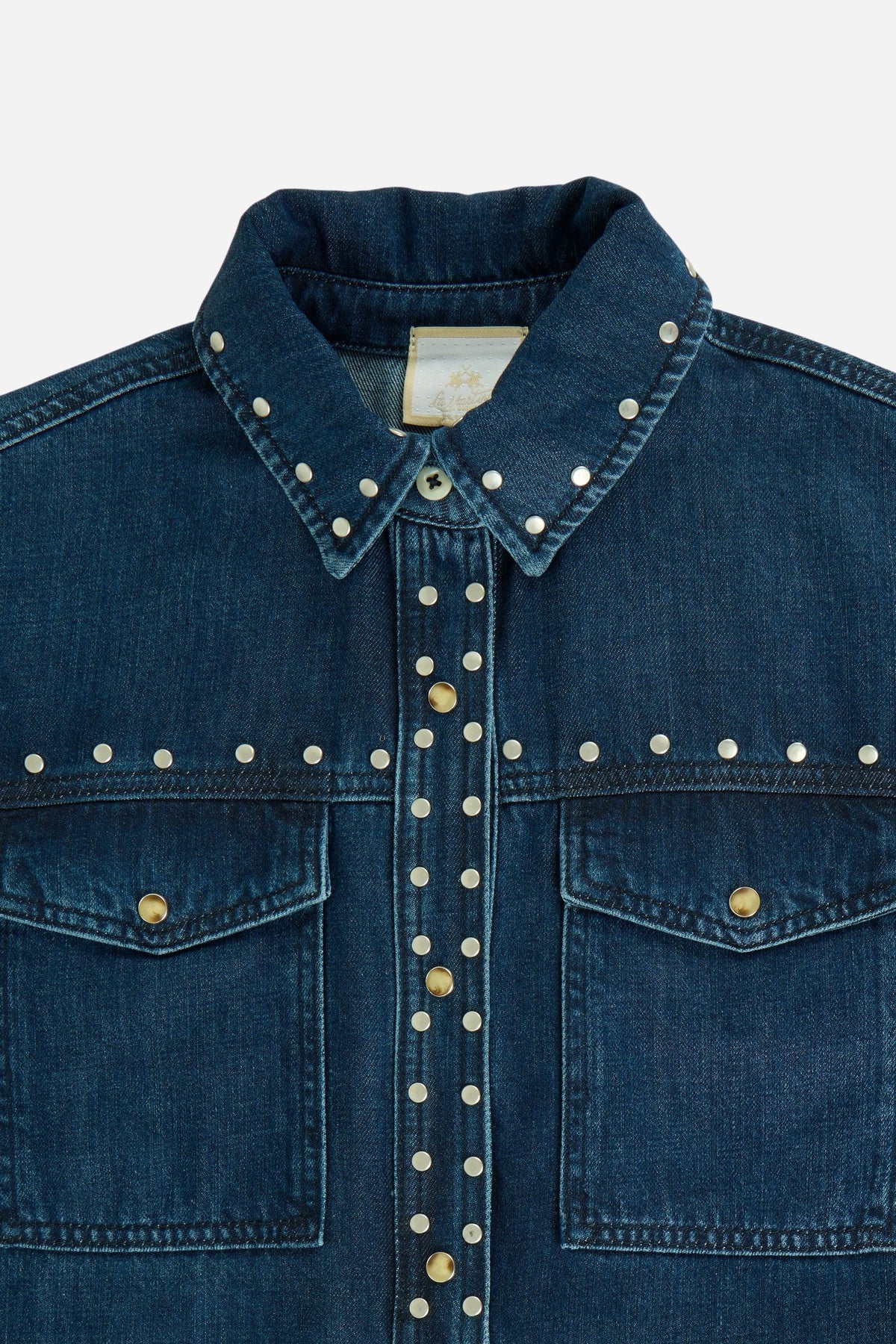 Women's 100% cotton denim shirt with a sturdy structure, dark blue wash, metal rivet details, snap button closure, two flap pockets, and embroidered logo. - Dark Indigo Denim