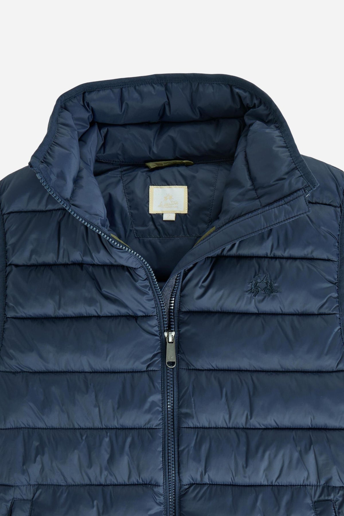 Women's nylon vest with polyamide lining and polyester padding, featuring horizontal quilting, high collar, zip closure, fleece-lined pockets, and adjustable hem for comfort. - Navy Blazer