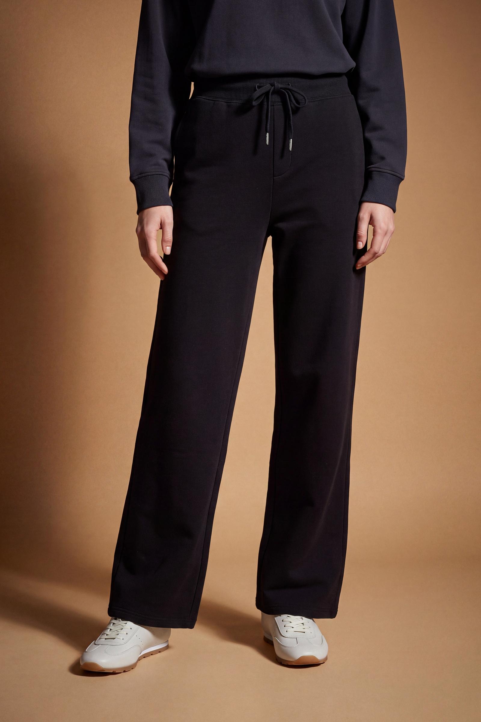 Women's pants in soft brushed cotton with an elastic waistband, adjustable drawstring, vertical side pockets, and a relaxed wide-leg fit for all-day comfort. - Black