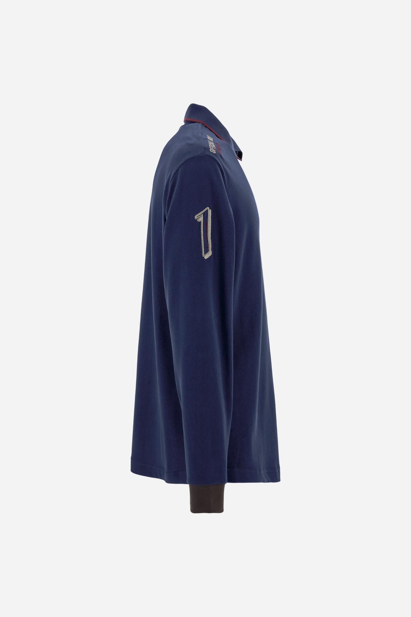 Men’s long-sleeve polo shirt in solid-colour cotton jersey with a warm, matte handfeel. Ribbed collar and cuffs with stripes and colour blocks in contrast, two personalised buttons and contrast details inside the collar. Patches and graphics on sleeves and chest celebrate the Official Polo Supplier team. The large multicolour logo is embroidered on the chest. Regular fit. The model wears size L. - Navy