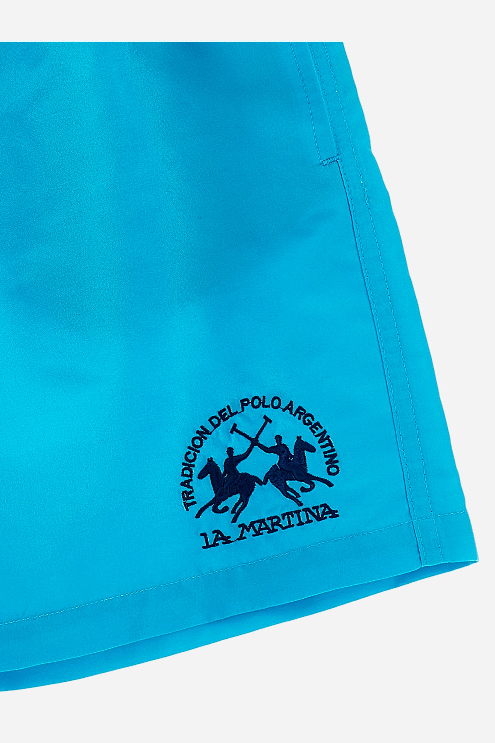 Boys' single-colour costume in synthetic fabric with elasticated waist, front slanted pockets, a contrasting back pocket, and embroidered logo. - Blue Atoll