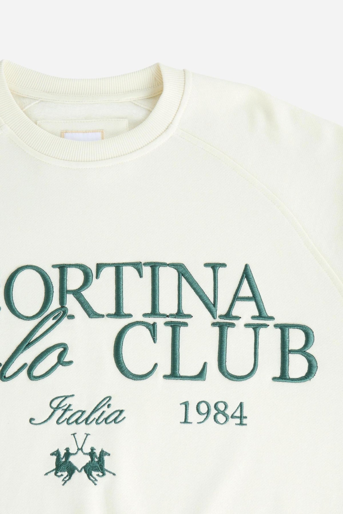 Women's long-sleeve sweatshirt in soft brushed cotton with ribbed crew neck, cuffs, and hem. Relaxed fit with embroidered large Cortina Polo Club logo for style and comfort. - Pristine