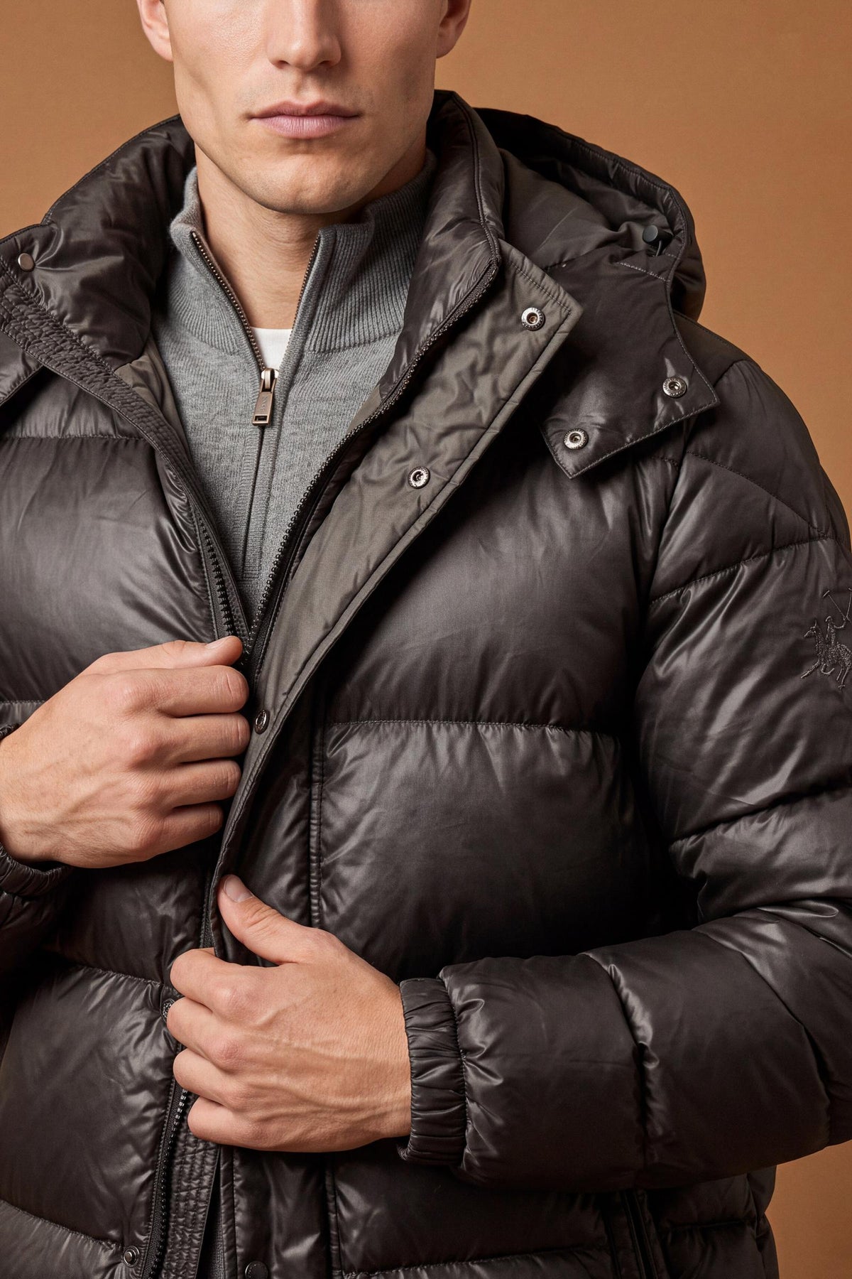 Men's padded feather bomber jacket with detachable hood, iridescent nylon, double zipper, snap buttons, adjustable drawstring, zippered pockets, and embroidered logo. - Black