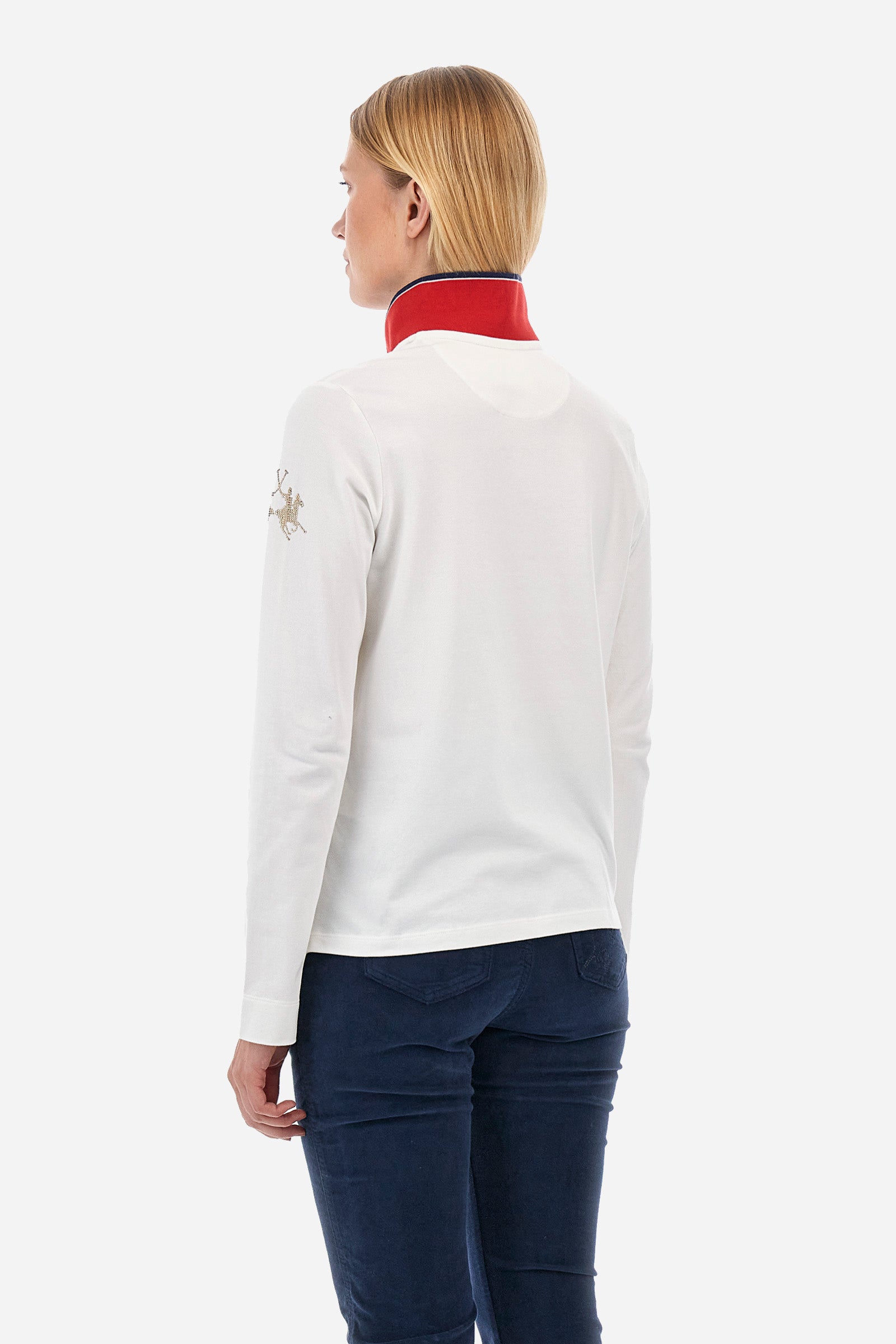 Women's long-sleeved polo shirt in stretch cotton, with regular lines in the Polo Academy style. The collar is classic, with a V neckline and double jewel button. Available in solid colour with different fun prints in contrasting colours on the garment. Featuring a rhinestone logo on the sleeve. This garment is designed for the practical and sporty woman who seeks comfort and style without sacrificing quality. Suitable for any occasion. The model is 174 cm tall and wears a size 2. - Off White
