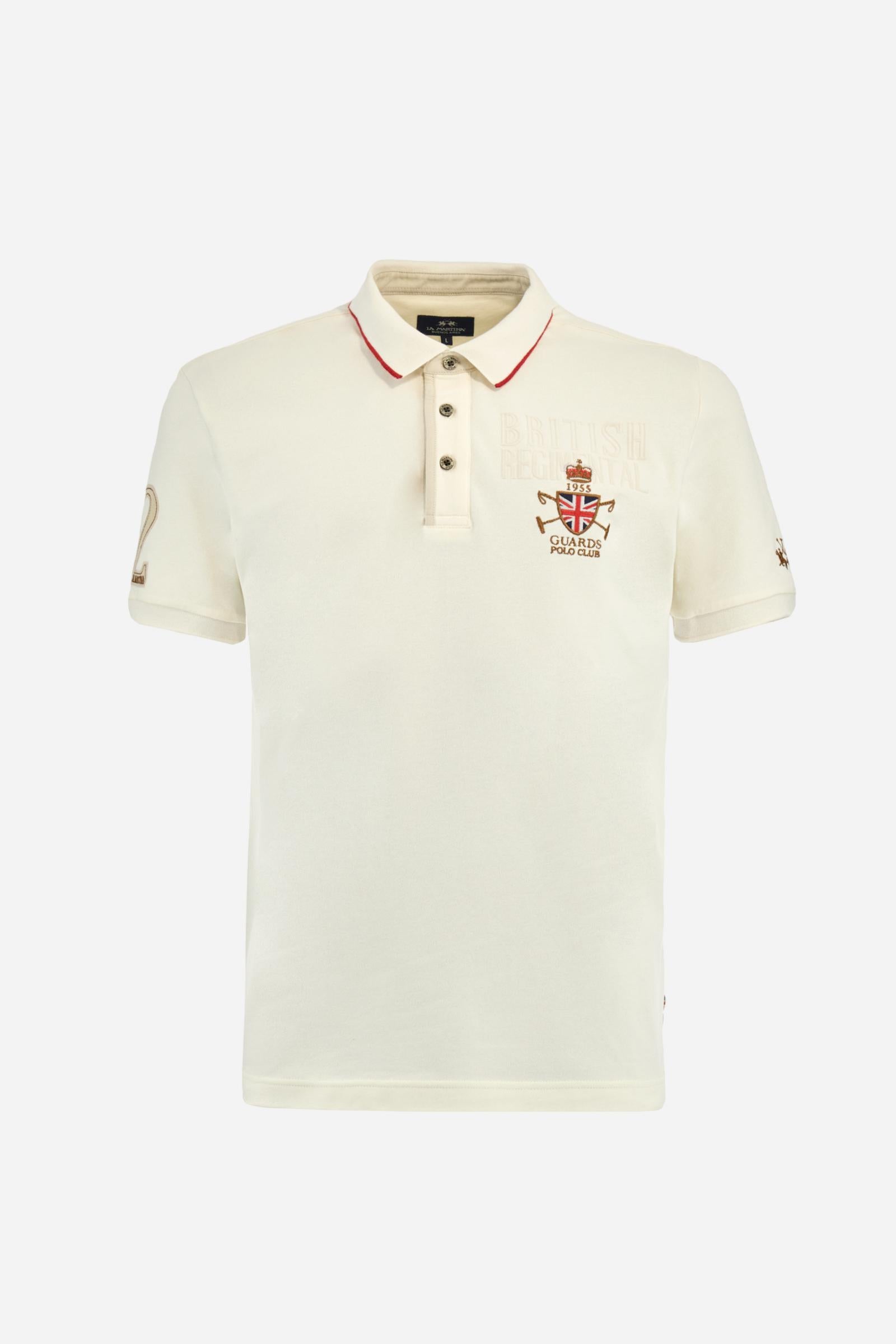 Short-sleeve polo shirt from the Guards capsule, made of high-quality stretch cotton piqué. Ribbed collar and cuffs in matching tone, with contrast striped detail on the collar. Three-button personalized placket. Multicolor graphics, patches, and lettering celebrate the British regiment, applied to chest and sleeves. Brand logo embroidered in contrast on the left sleeve. Regular straight fit. Model wears size L. - Pristine
