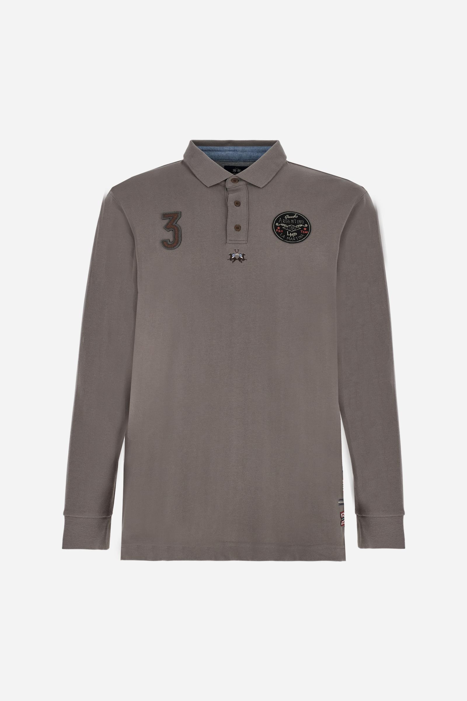 Long-sleeve polo shirt crafted from 100% high-quality cotton jersey. The velvety fabric offers a warm, cozy feel, perfect for cooler seasons. Ribbed collar and cuffs in matching tone, with a three-button personalized placket. A small multicolor embroidered logo sits below the opening, while tonal patches in different shapes and textures, inspired by Argentine culture and Gaucho tradition, decorate the chest and back. Classic regular fit. Model wears size L. - Falcon