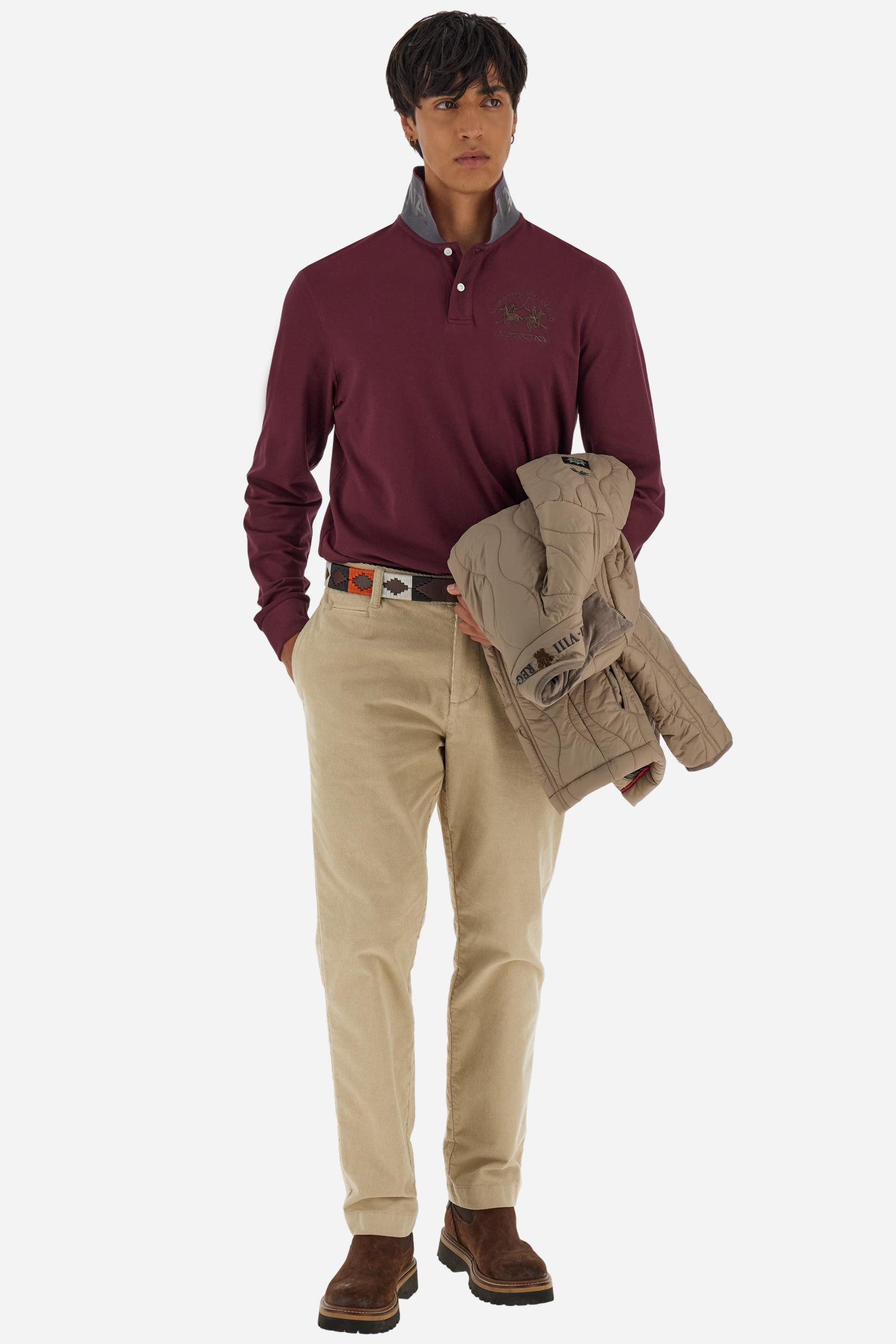 Men's long-sleeved solid colour polo shirt. Made of high-quality stretch Piqué. The collar and cuffs are in solid colour ribbing. The undercollar features a print of the iconic La Martina lettering in a contrasting colour. Featuring a logo embroidered on the chest in a contrasting colour. On the back at the bottom, the guarantee label typical of the brand's iconic models is applied. Regular fit. The model is wearing a size L. - Port Royale