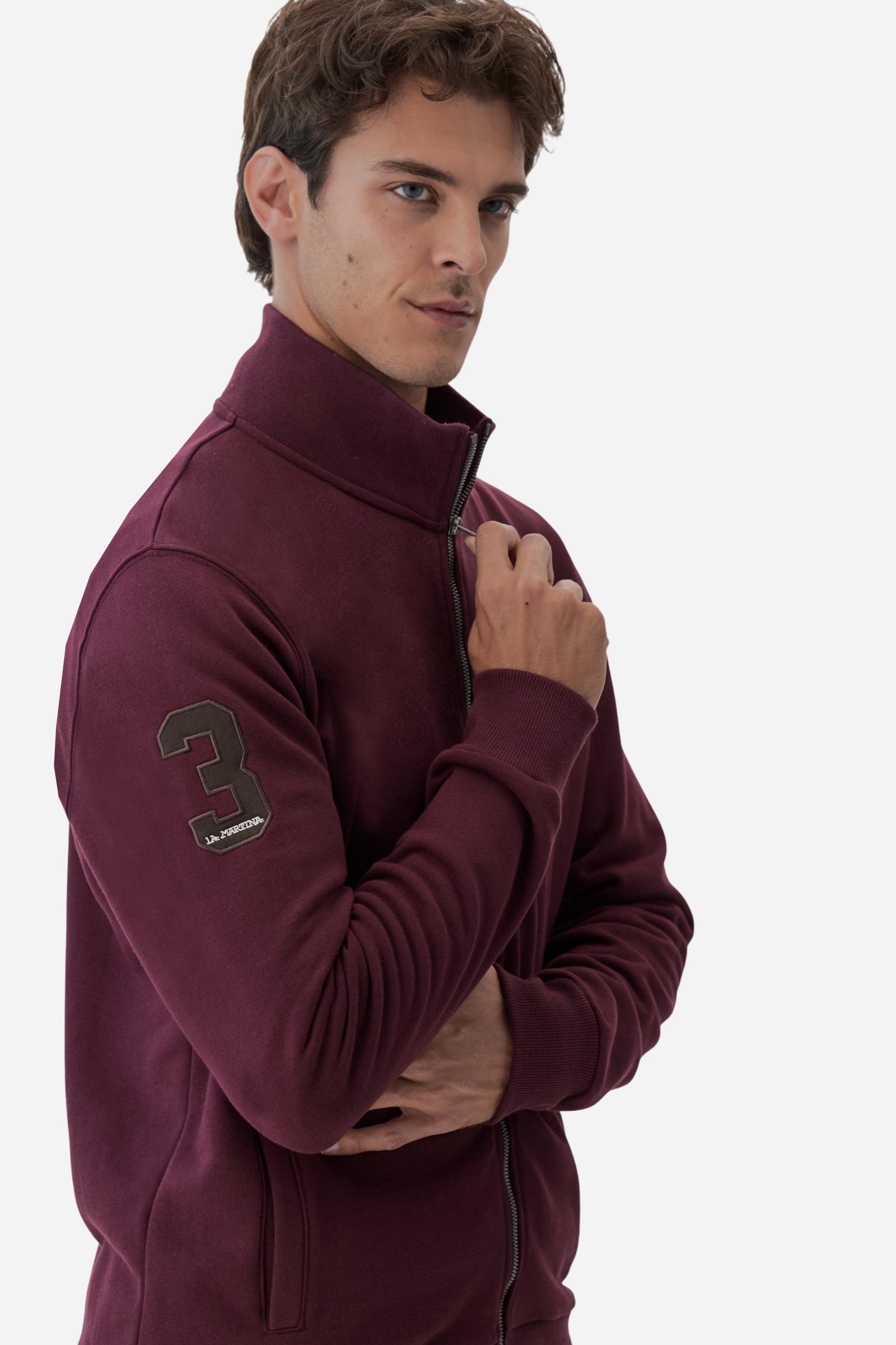 Men's long-sleeved solid colour sweatshirt. It is made of comfortable 100% cotton fleece with a soft-brushed feel. Model with high ribbed neck and front zip opening. Solid colour ribbed cuffs and waistband. The large contrasting brand team logo is embroidered on the chest. A contrasting colour fabric number patch is applied to the right sleeve. The model has a regular fit that offers a comfortable, relaxed silhouette. The model is wearing a size L. - Port Royale