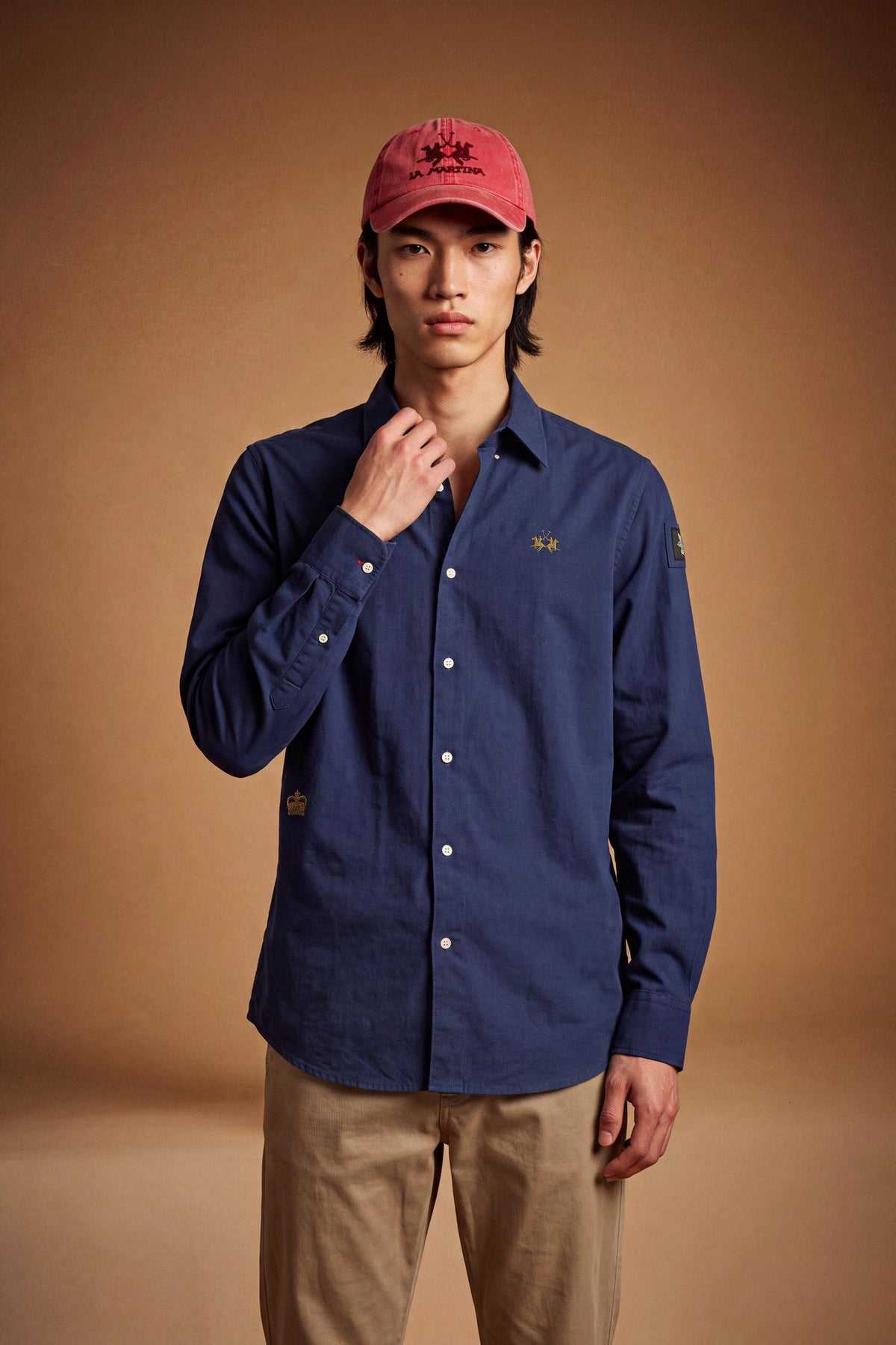 Men’s long-sleeve 100% cotton Oxford shirt with classic collar, button closure, embroidered details, red contrast stitching, and a comfortable regular fit with rounded hem. - Navy