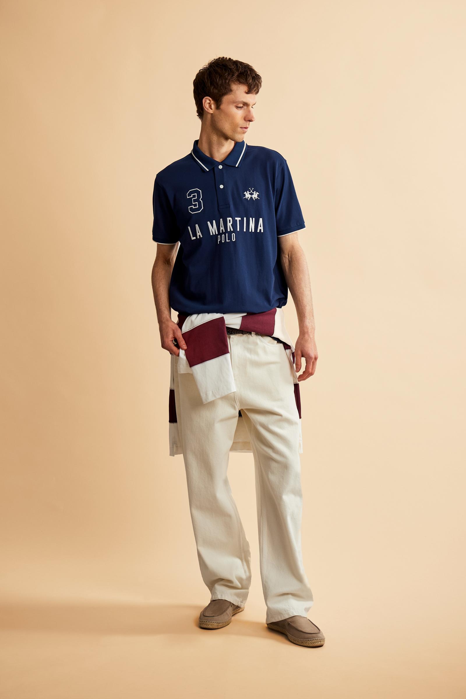 Men's short-sleeve polo in stretch piqué fabric with ribbed details, embroidered logo, bold lettering, and a relaxed regular fit for versatile comfort. - Navy
