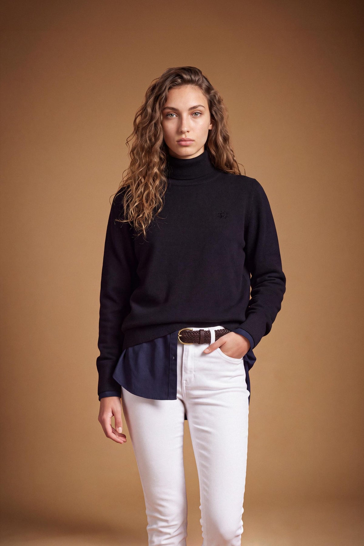 Women's lambswool turtleneck sweater with a soft, ribbed collar, fitted bust, ribbed cuffs and hem, and subtle embroidered logo for a clean, elegant look. - Black