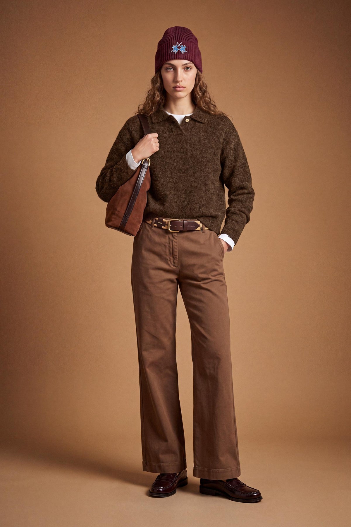 Women's long-sleeve knitted polo in soft lambswool blend, featuring a relaxed cropped fit, ribbed cuffs, shirt-style collar, and smooth, compact knit surface. - Hot Fudge
