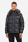 Men's single-colour quilted bomber jacket with hood and zip fastening, made of synthetic fabric. Featuring two front pockets with zip closure. Removable hood. The logo can be found on a patch applied to one of the sleeves. Regular fit. The model is wearing a size L. - Black