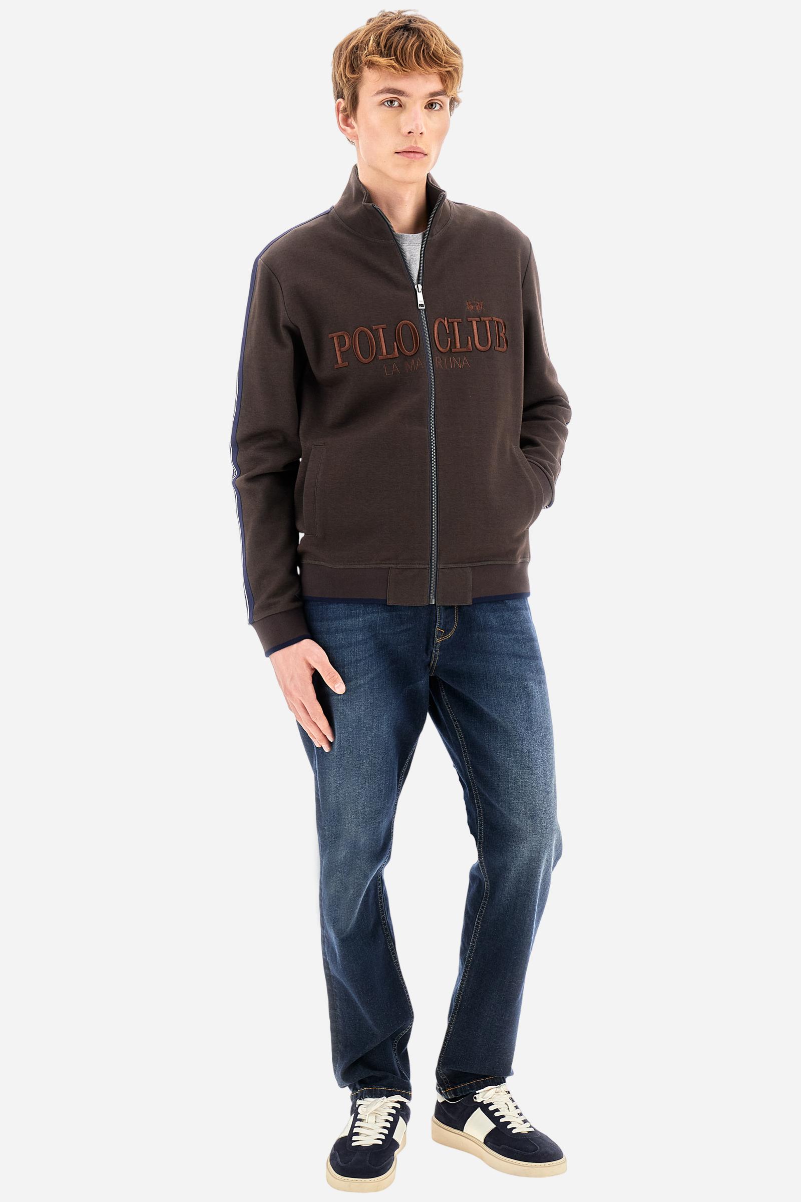 Men’s jeans in stretch cotton denim. Five-pocket style with personalized metal rivets. Waist with 5 belt loops. Front zip fastening and personalized branded button. Embroidered contrasting logo inside the right front coin pocket. Customized back label on the waistband. Slim leg with regular waist and shaped cut at crotch and thighs. Model wears size 33. - Dark Indigo Denim