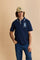 Men's short-sleeve polo shirt made from heavy-weight cotton jersey in solid color. The model features a front opening in contrasting jersey with vertically embroidered chain stitching. The collar and cuffs are ribbed with contrasting edge detail. The design is enriched with an embroidered crest on the chest dedicated to Saint Tropez and the iconic two polo players logo embroidered on the back. The fit follows modern trends with a slightly oversized silhouette, dropped shoulders and a relaxed shape. The mode