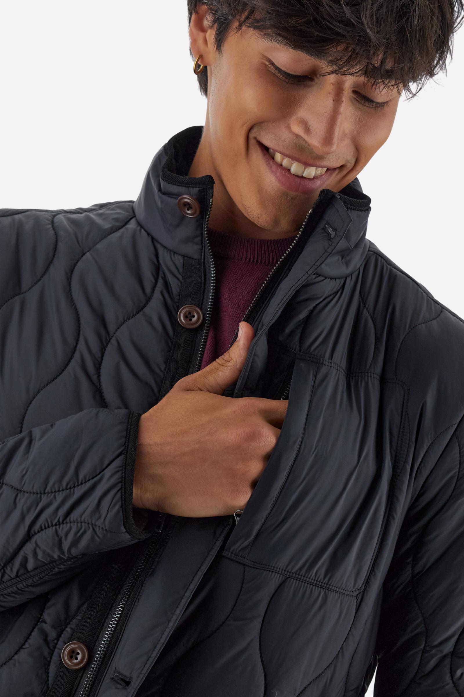 Men’s quilted nylon husky jacket with high collar. Front closure with customized zip and large faux-leather buttons. Interior lined with striped bicolor polyester. Contrast details on the inside (pockets, profiles, back-neck tab). Clean design with chest pocket closed by zip and vertical side pockets. Adjustable back straps with metal snap buttons. Logo patches on the sleeves and multicolor embroidered lettering on the outer collar. Part of the Guards capsule. Regular fit. Model wears size L. - Black