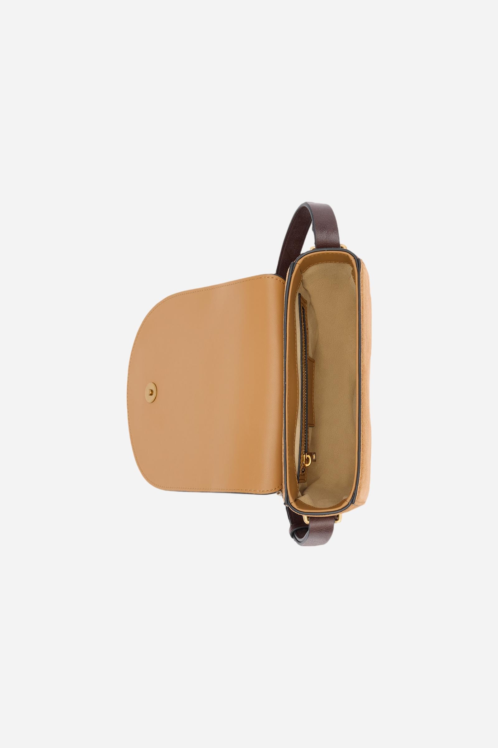 Crossbody bag featuring a curved design inspired by the shape of a saddle. Crafted from soft suede paired with smooth, structured leather details. The large front flap, secured with a hidden magnetic closure, is embellished with a gold-tone stirrup engraved with the brand logo. A leather band runs along the entire profile, reinforcing the structure and recalling traditional saddle craftsmanship. Fixed, adjustable leather shoulder strap. Dimensions:19 x 16 x 6 - HONEY/DARK CHOCOLATE