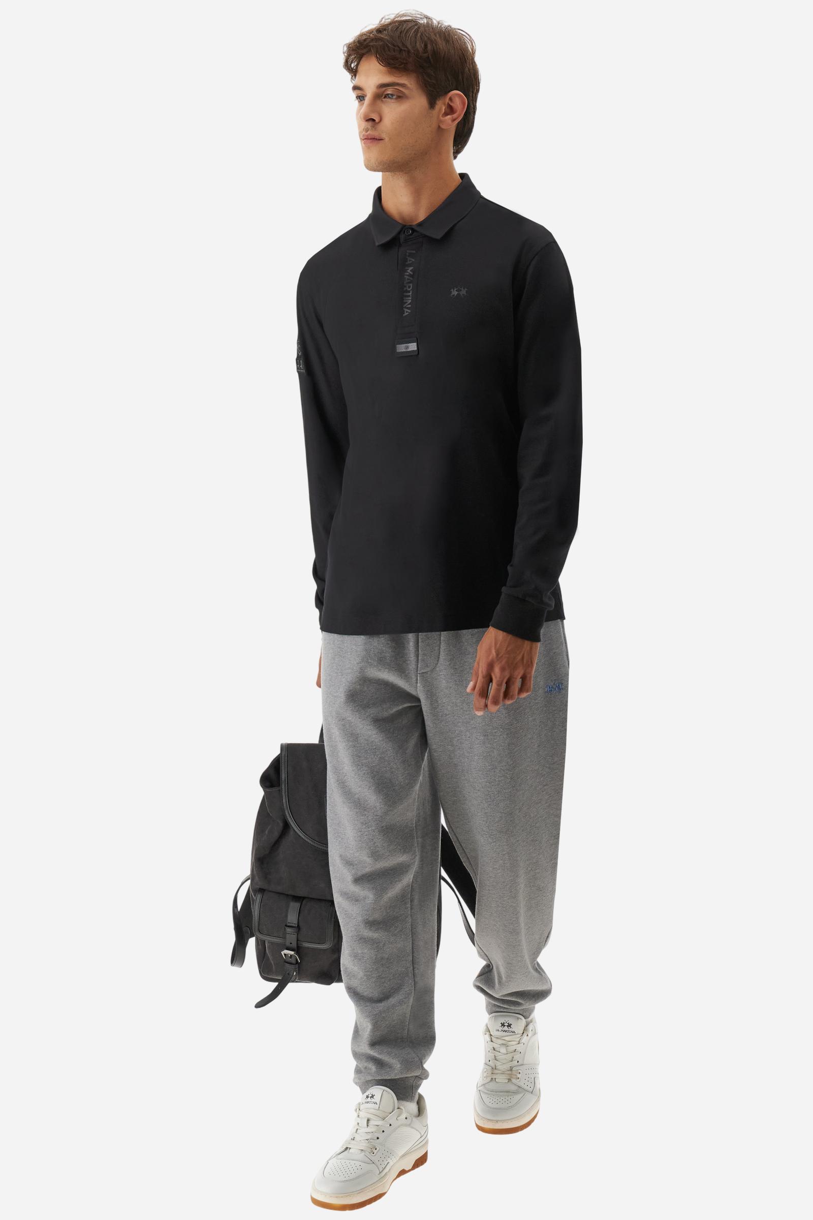 Premium men’s long-sleeve polo shirt in 100% cotton jersey with a smooth, silky texture. Hidden button placket and vertical contrast print. Patches dedicated to the Asociación Argentina de Polo (AAP) on the sleeve and below the opening. Small semi-transparent contrasting logo printed on the chest. Regular fit. The model wears size L. - Black