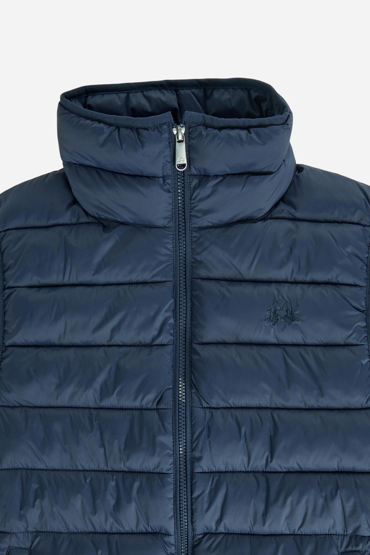 Women's nylon vest with polyamide lining and polyester padding, featuring horizontal quilting, high collar, zip closure, fleece-lined pockets, and adjustable hem for comfort. - Navy Blazer