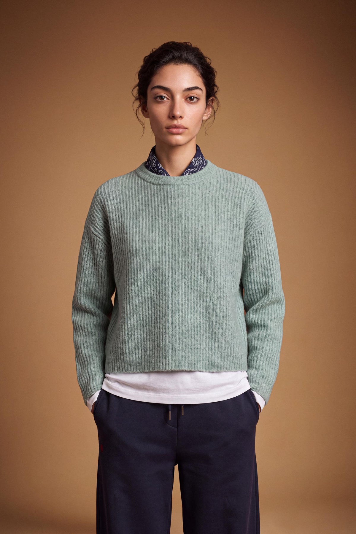 Soft lambswool women's sweater with vertical ribbed knit, relaxed fit, dropped shoulders, cropped length, and a subtle embroidered logo on the back neckline. - Desert Sage