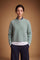 Soft lambswool women's sweater with vertical ribbed knit, relaxed fit, dropped shoulders, cropped length, and a subtle embroidered logo on the back neckline. - Desert Sage