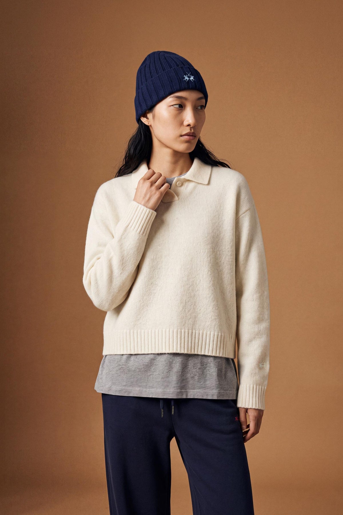 Women's long-sleeve knitted polo in soft lambswool blend, featuring a relaxed cropped fit, ribbed cuffs, shirt-style collar, and smooth, compact knit surface. - Antique White