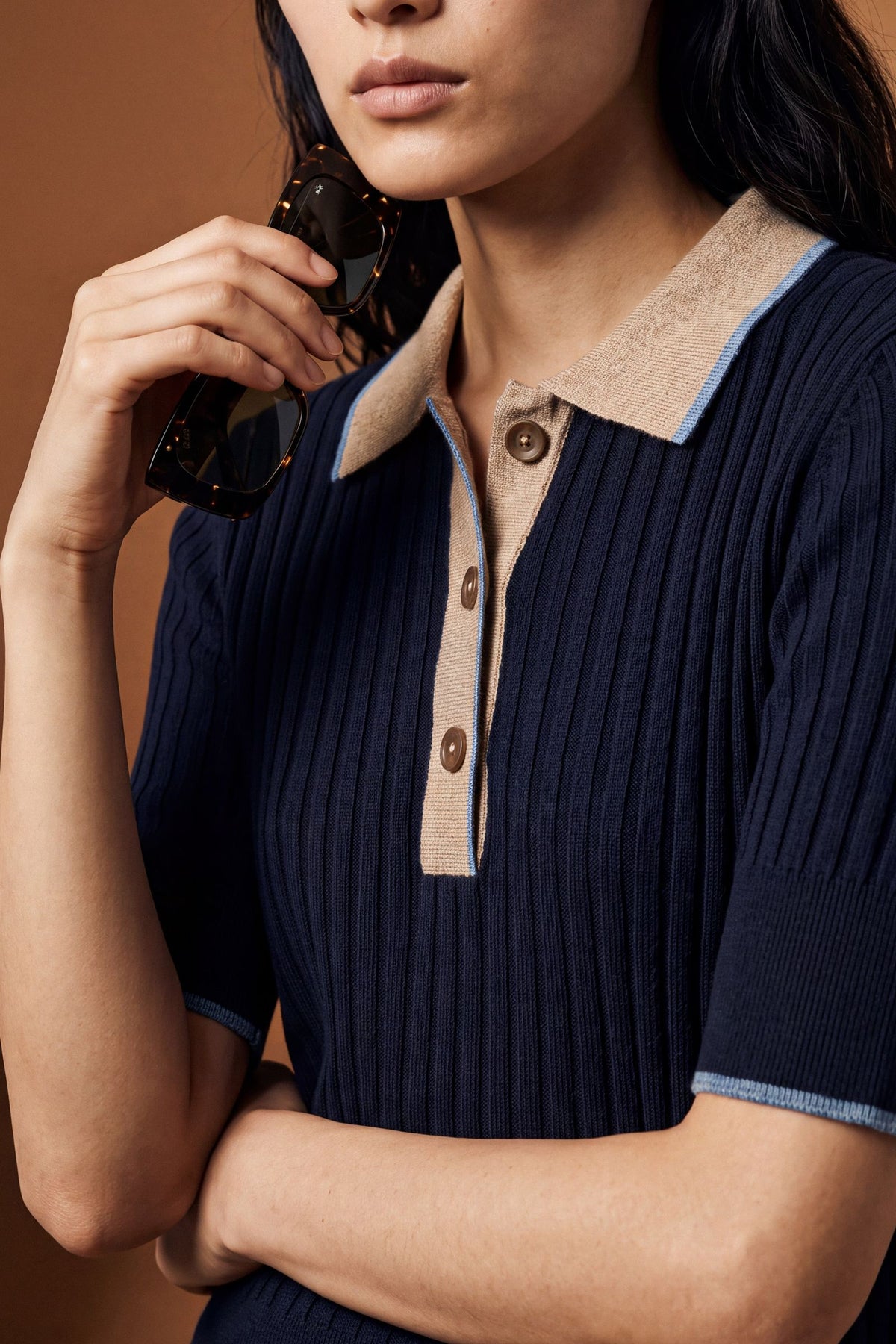 Slim-fit women's short-sleeve polo made from soft lambswool blend with vertical ribbing, ribbed collar, cuffs, and hem, featuring contrasting trims and a three-button front. - Navy