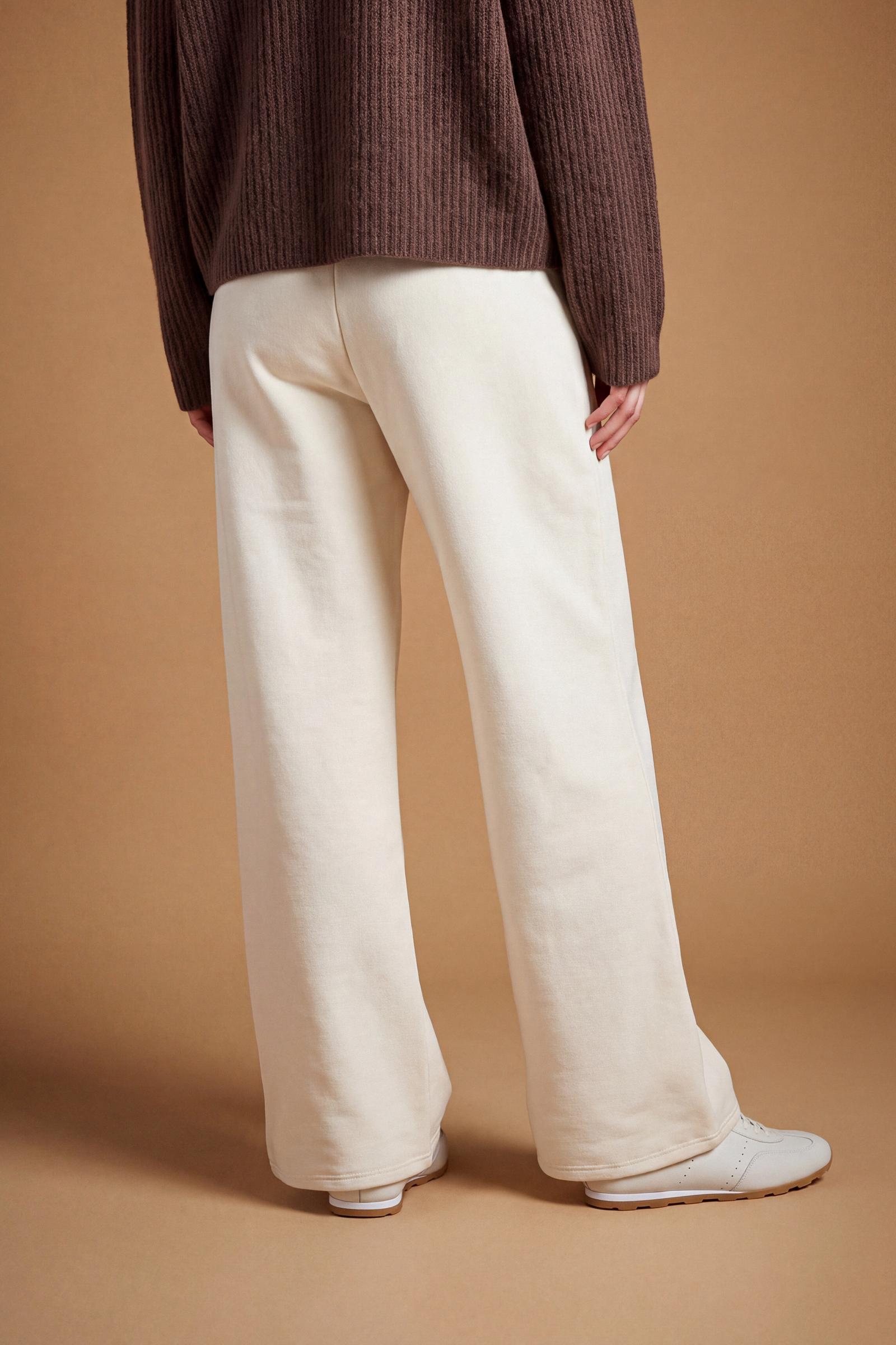 Women's pants in soft brushed cotton with an elastic waistband, adjustable drawstring, vertical side pockets, and a relaxed wide-leg fit for all-day comfort. - Pristine