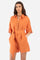 Women's one-piece playsuit with 3/4 sleeves with cuff and single-colour shorts. In 100% linen. French collar. With button fastening. Belt loops and fabric belt included. Featuring two front welt pockets and two back pockets. A logo and the lettering "La Martina" are embroidered on the back. The fit is regular. The model wears a size IT40. - Celosia Orange