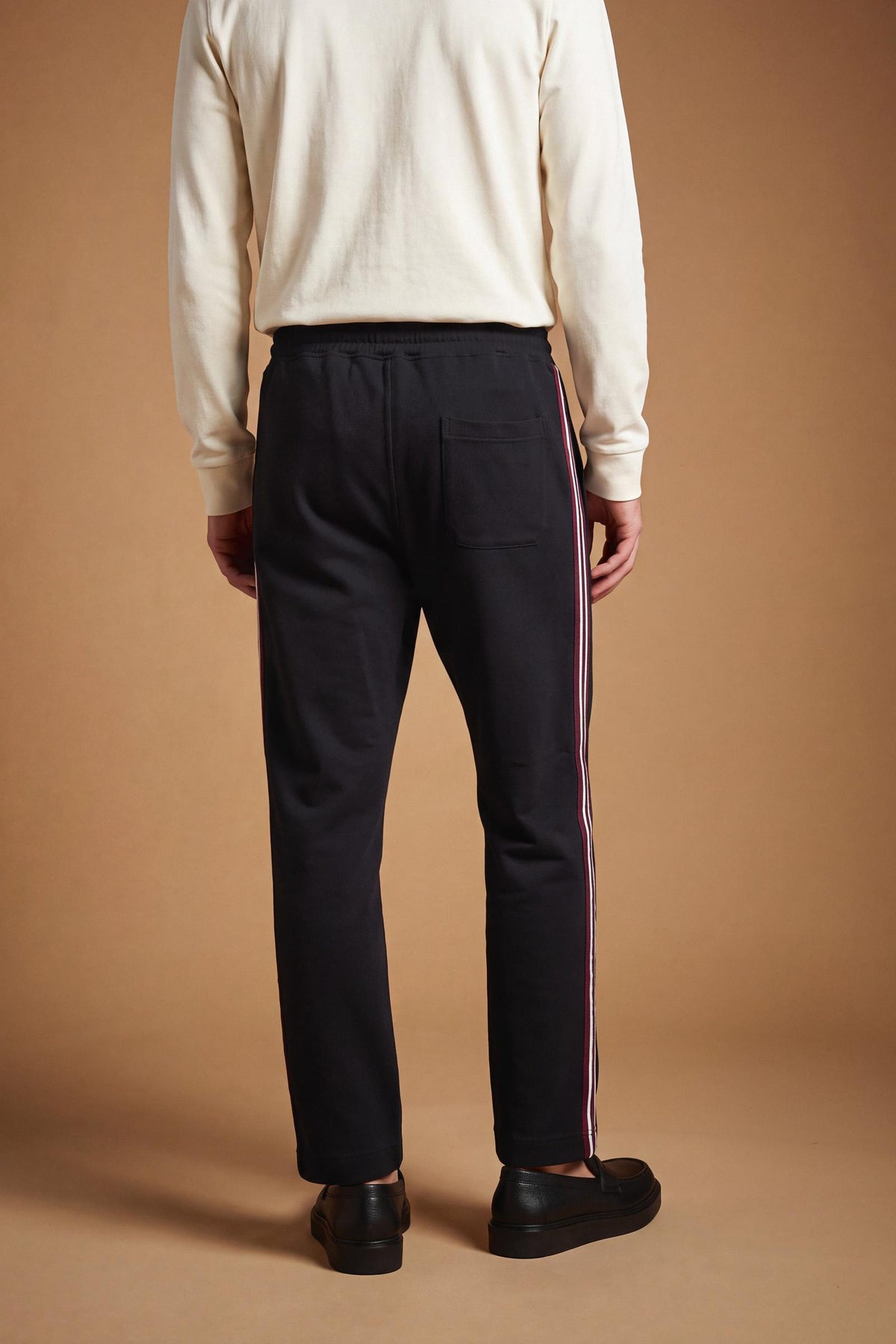 Men's cotton interlock jogging pants with elastic waistband, adjustable drawstring, side and back pockets, multicolored stripes, and a soft, sporty silhouette. - Black