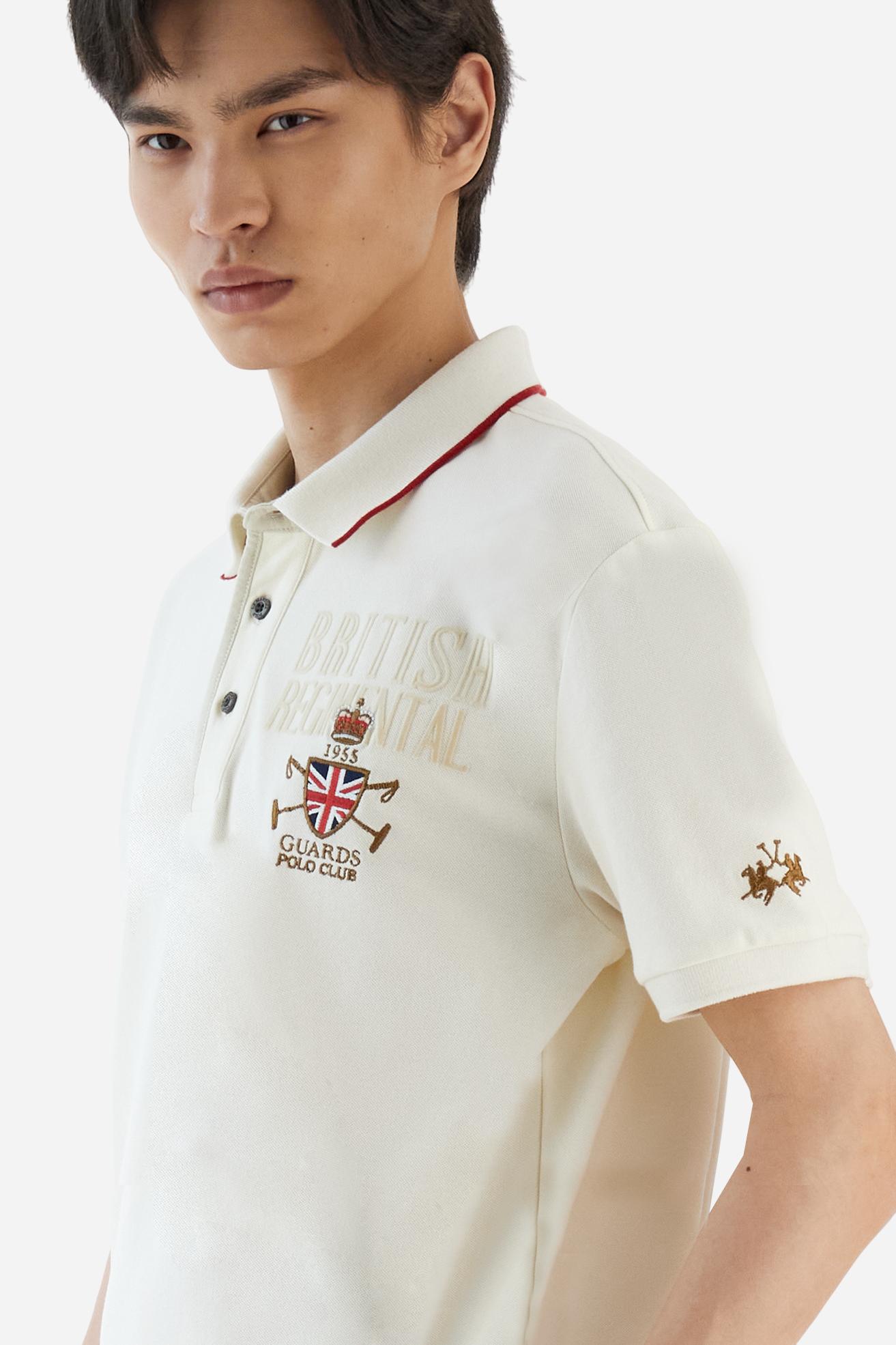 Short-sleeve polo shirt from the Guards capsule, made of high-quality stretch cotton piqué. Ribbed collar and cuffs in matching tone, with contrast striped detail on the collar. Three-button personalized placket. Multicolor graphics, patches, and lettering celebrate the British regiment, applied to chest and sleeves. Brand logo embroidered in contrast on the left sleeve. Regular straight fit. Model wears size L. - Pristine