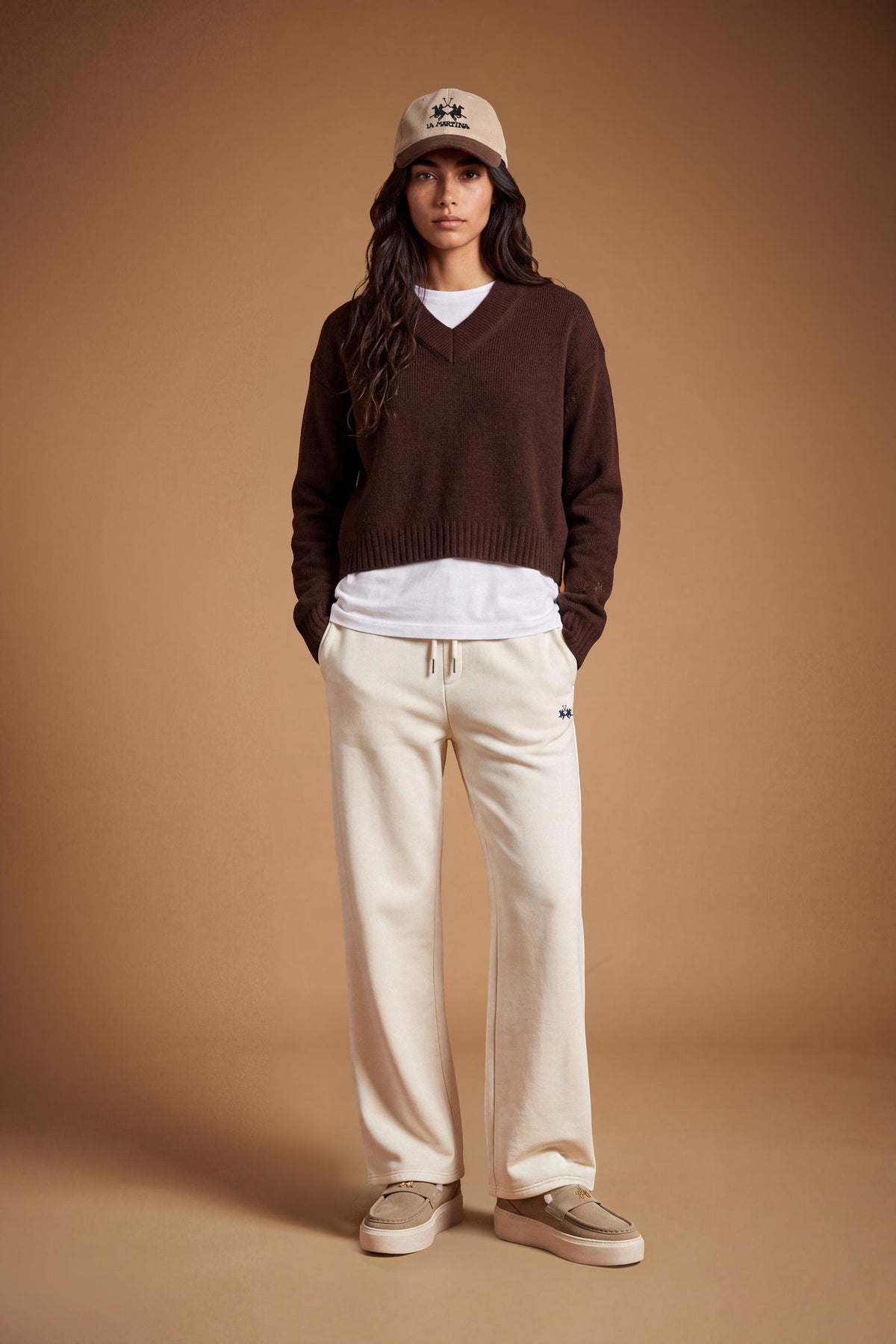 Women's long-sleeve sweater in soft 100% merino wool with a relaxed, slightly oversized fit, V-neck, ribbed cuffs and hem, and a modern cropped length. - Hot Fudge