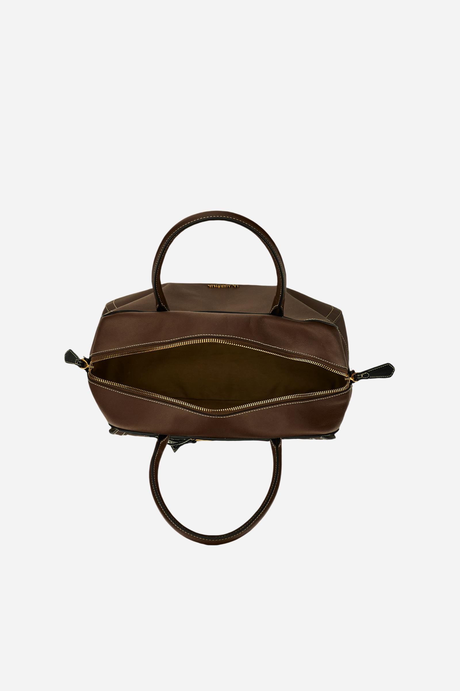 Elegant women's tote in full-grain leather with semi-rigid structure, gold-tone stirrup detail, double handles, adjustable strap, and roomy, secure interior. - Sienna/Black