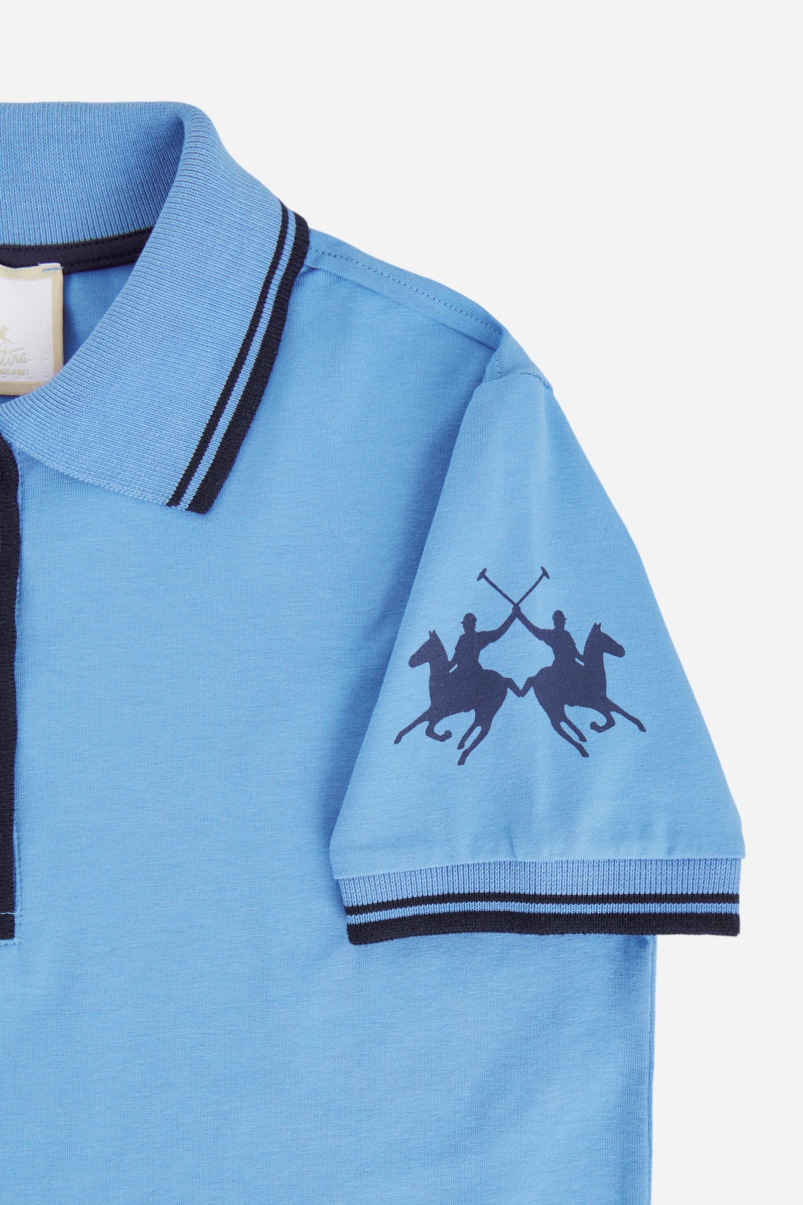 Short-sleeved polo dress for girls made from pure cotton piqué in a solid colour. The style features a comfortable fit, fluid silhouette and above-the-knee length. The two-tone ribbed collar, buttoned front opening and striped trims add a sporty and refined touch. The logo on the sleeve and the lettering under the collar complete the design. - Riviera