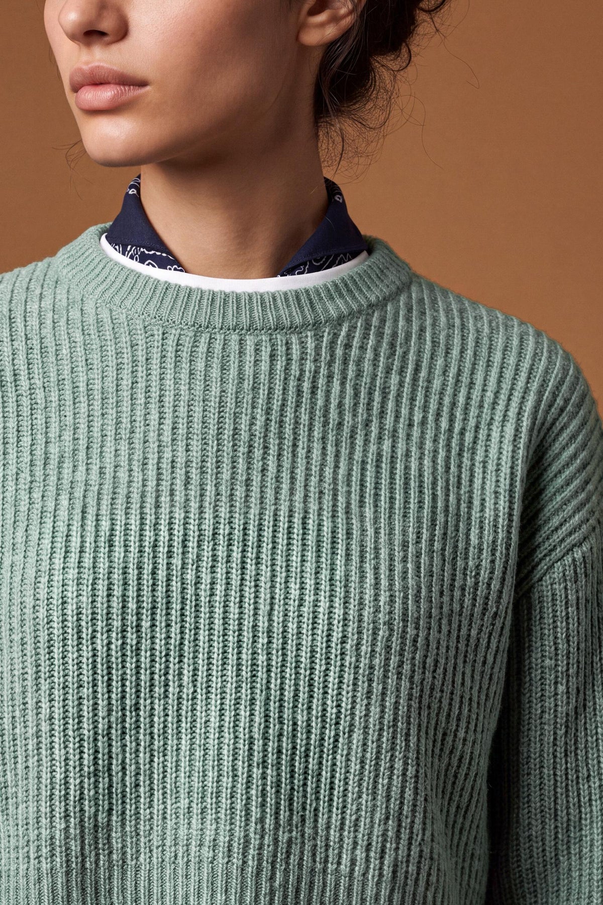 Soft lambswool women's sweater with vertical ribbed knit, relaxed fit, dropped shoulders, cropped length, and a subtle embroidered logo on the back neckline. - Desert Sage