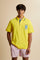 Men's short-sleeve polo shirt made from heavy-weight cotton jersey in solid color. The model features a front opening in contrasting jersey with vertically embroidered chain stitching. The collar and cuffs are ribbed with contrasting edge detail. The design is enriched with an embroidered crest on the chest dedicated to Saint Tropez and the iconic two polo players logo embroidered on the back. The fit follows modern trends with a slightly oversized silhouette, dropped shoulders and a relaxed shape. The mode