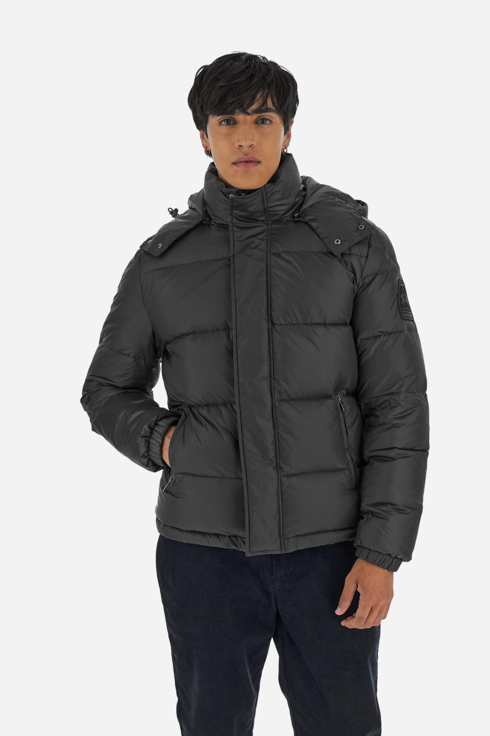 Men’s padded bomber jacket with detachable hood. Made of solid iridescent nylon with contrast lining. Equipped with two practical inner braces for extra comfort. Double customized zip front closure with inner placket featuring contrast Polo Player print, closed with metal snap buttons. Two vertical zipped pockets on the front. Hood with contrast lining and adjustable elastic drawstring. Bold Polo Player graphics printed inside. Regular fit for comfortable movement without bulk. Model wears size L. - Black