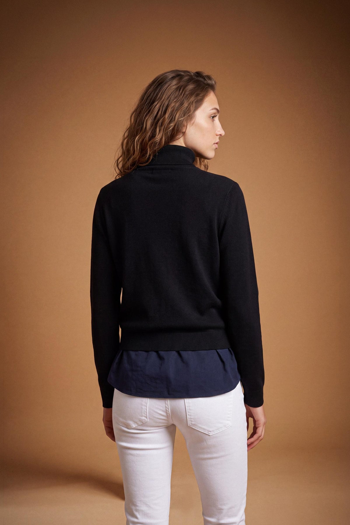 Women's lambswool turtleneck sweater with a soft, ribbed collar, fitted bust, ribbed cuffs and hem, and subtle embroidered logo for a clean, elegant look. - Black
