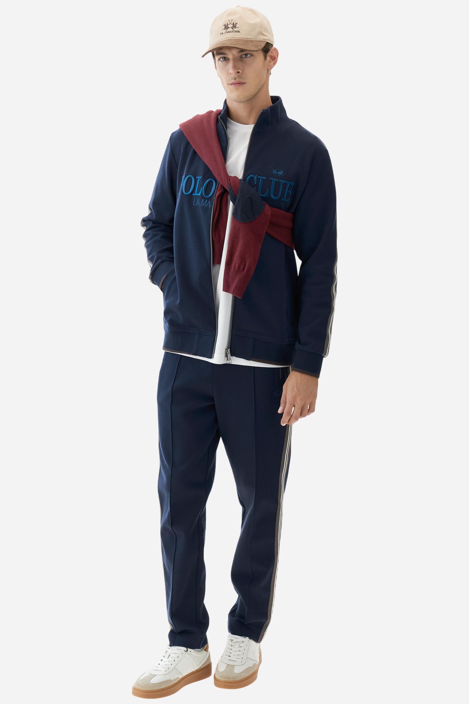 Men's long-sleeved, full-zip sweatshirt. Made of soft solid colour cotton fleece. The neck and cuffs and waistband are in solid colour ribbed knit with contrasting edging. Front zip opening and Polo club guarantee label applied to the edge inside the collar. The front lettering is a large tone-on-tone raised embroidery. A narrow two-tone striped band is applied to the shoulders and sleeves. Regular fit. The model is wearing a size L. - Navy
