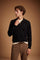 Men's long-sleeve polo made from 100% merino wool offers a comfortable fit, classic knitted collar, ribbed cuffs, and a subtle embroidered logo on the chest. - Black